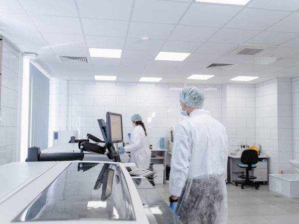 Profissionais de laboratório realizam pesquisas em um ambiente moderno e equipado.